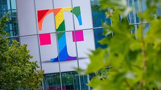 Deutsche Telekom logo in rainbow colors on the facade of an office building 
