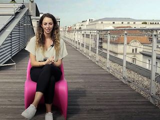 Women sitting on a chair on a rooftop