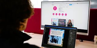 A trainee sits at the computer and creates content for social media