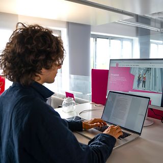 A trainee uses a laptop for research and to write a text