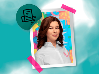 Portrait of a young woman with medium length brown hair and white blouse