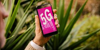 Hand with smartphone an 5G on display